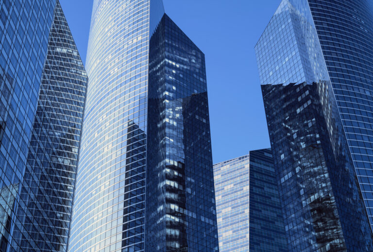 Close-up of modern office facades at business district at a clear  sunny day