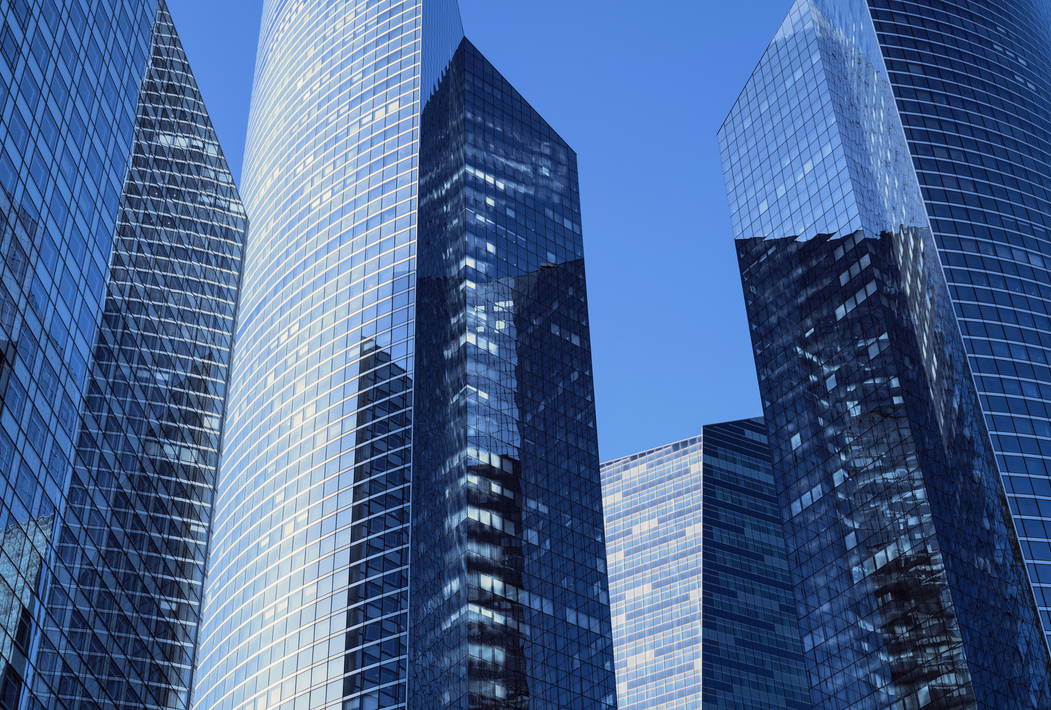 Close-up of modern office facades at business district at a clear  sunny day