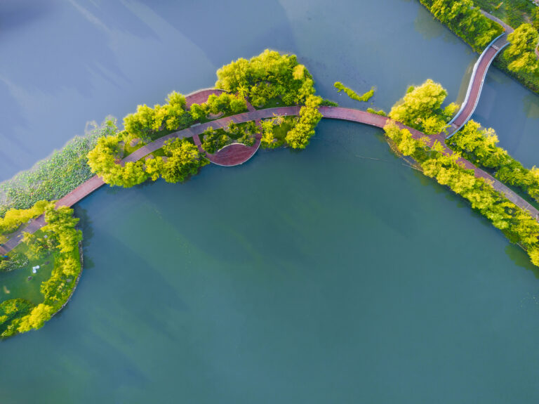 Aerial view on turquoise Lake  and forest with road on the bay