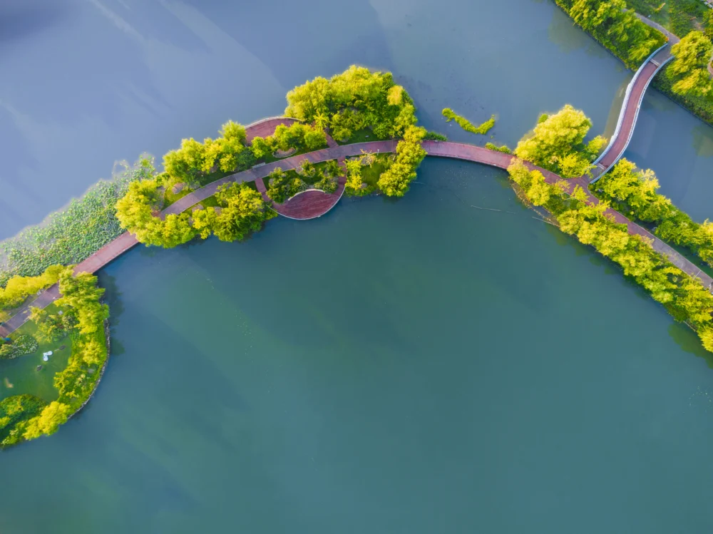 Aerial view on turquoise Lake  and forest with road on the bay