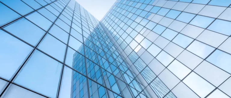 glass facades of modern office buildings and reflection of blue