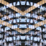 Reflections in glass office facade at dusk