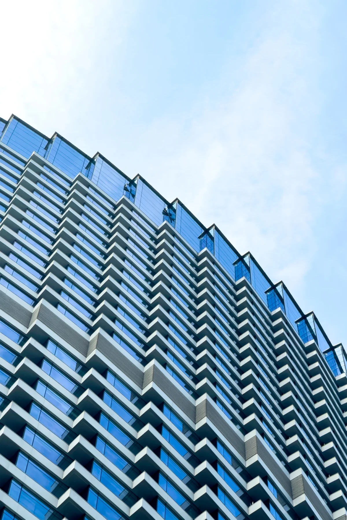 Looking up at the modern skyscrapers in city.