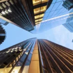 Looking up at illuminated London skyscrapers