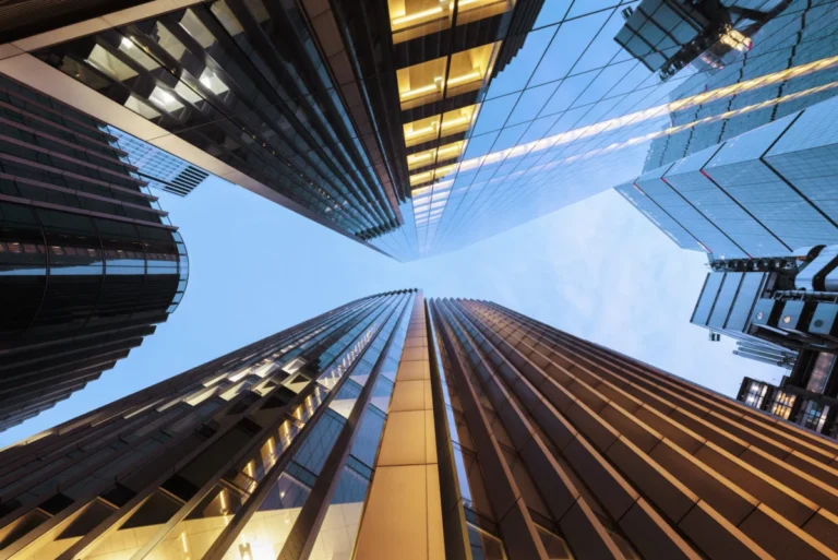 Looking up at illuminated London skyscrapers