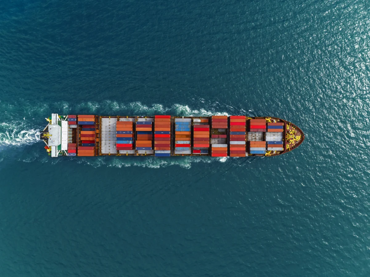 Aerial view of cargo ships in containers sailing in the sea.