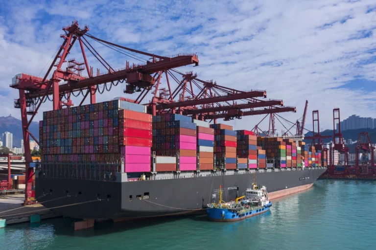 Container cargo ship at Terminal commercial port and working crane bridge loading container for business logistics, import export, shipping or transportation.