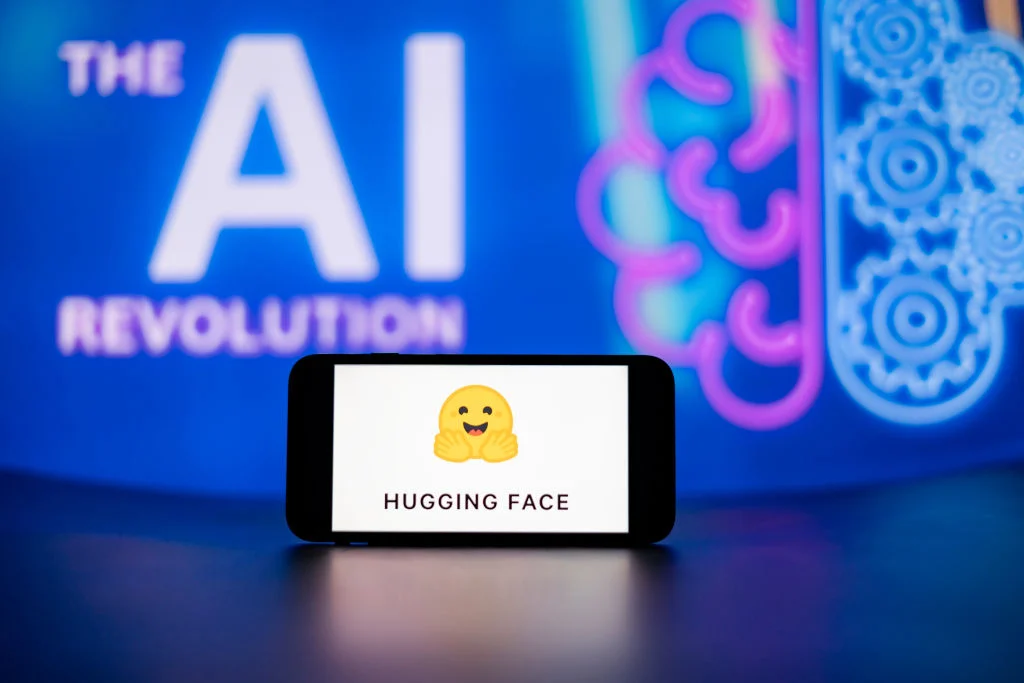 In this photo illustration, the Hugging Face logo seen