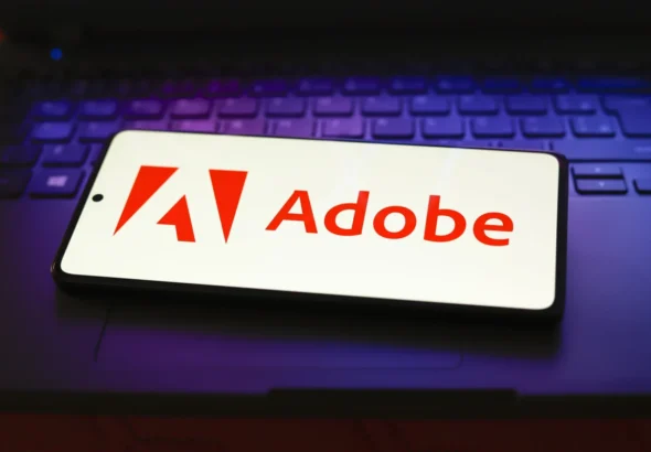 In this photo illustration, the Adobe Inc. logo is displayed
