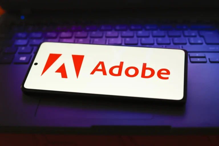 In this photo illustration, the Adobe Inc. logo is displayed