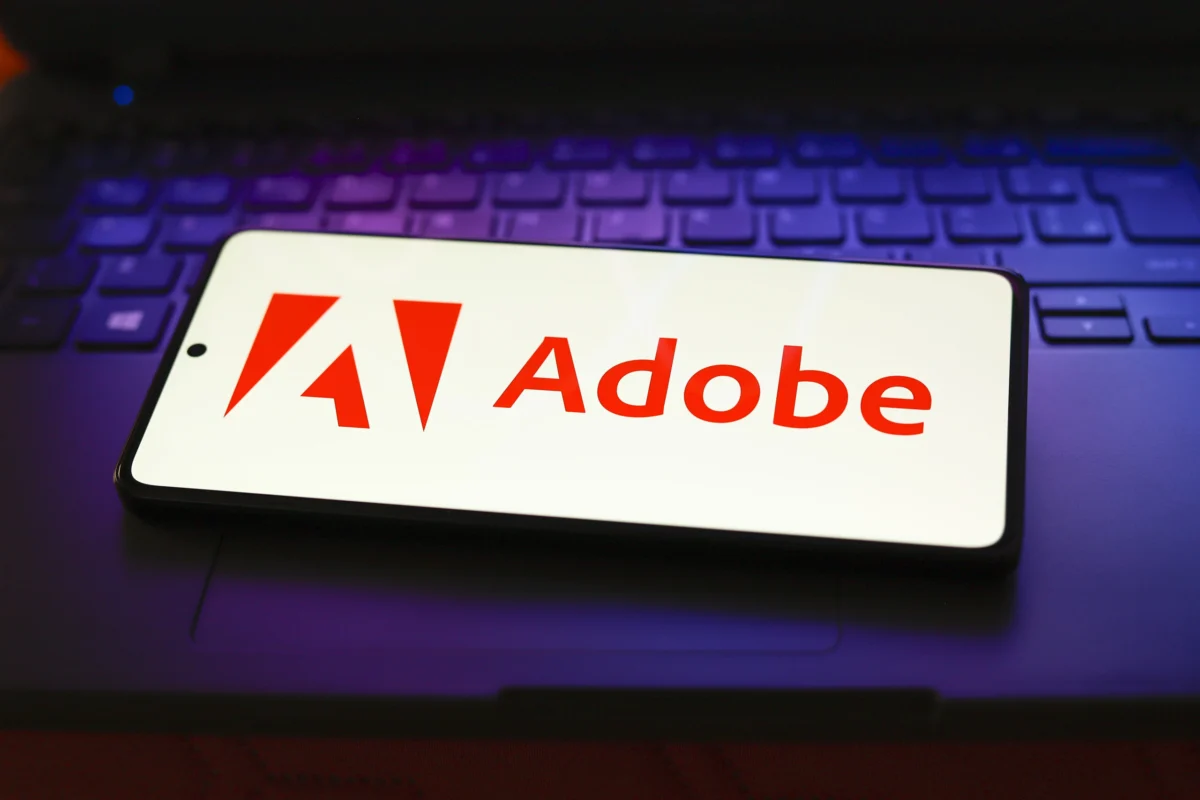 In this photo illustration, the Adobe Inc. logo is displayed