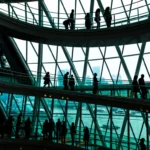 Abstract modern architecture and silhouettes of people on spiral staircase