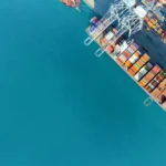 cargo ship and truck at seaport waiting for container dock crane