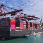 Container cargo ship at Terminal commercial port and working crane bridge loading container for business logistics, import export, shipping or transportation.